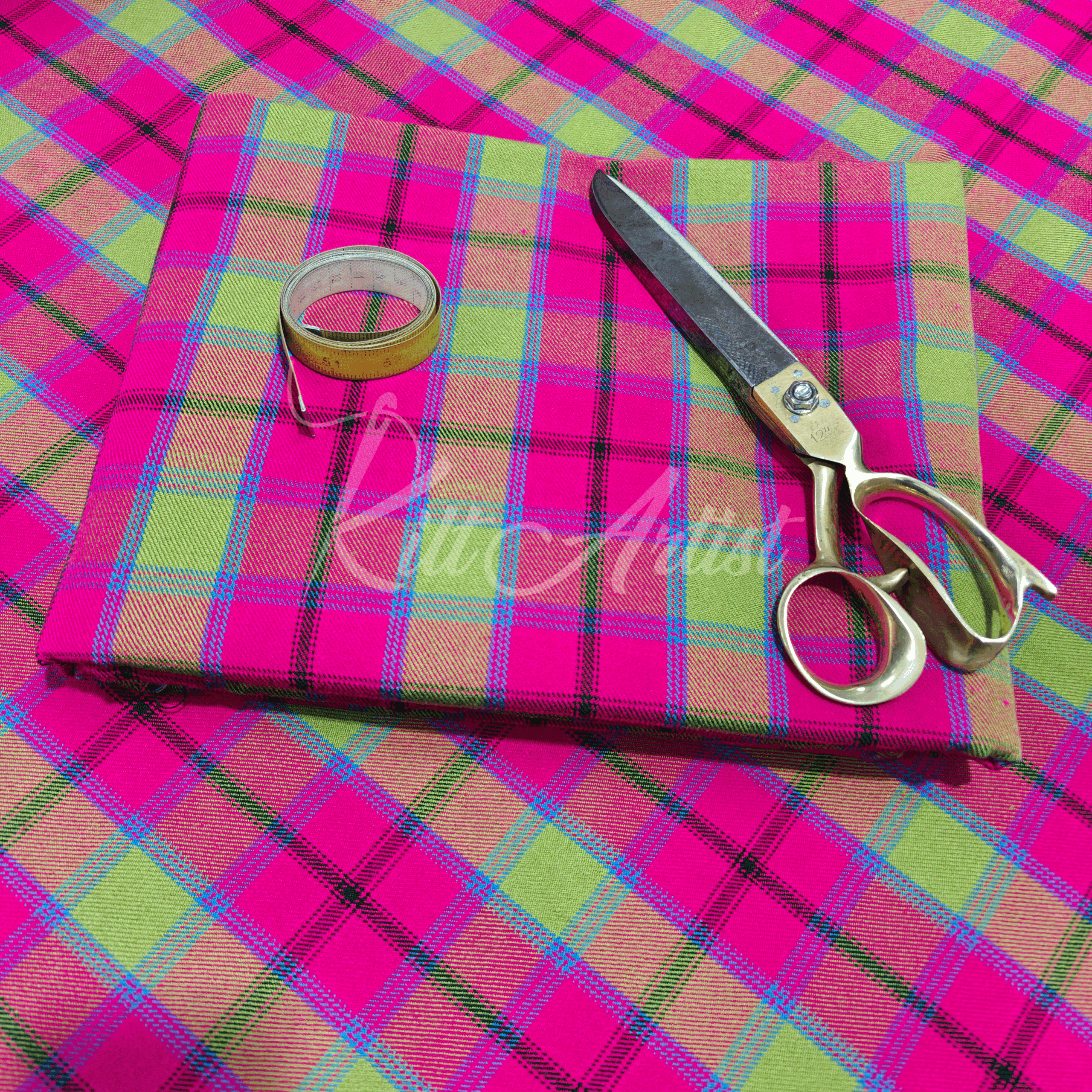 Vibrant pink and lime green tartan fabric featuring a diagonal crisscross pattern with blue and black accent stripes.
