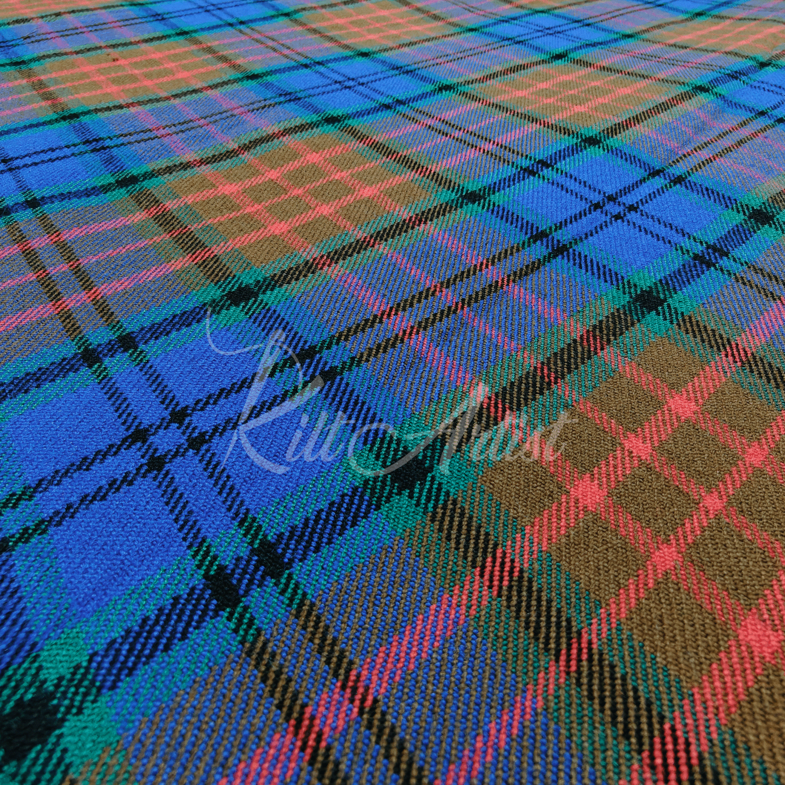 A hand holding a fold of Scottish Rivers tartan fabric featuring a vibrant mix of royal blue, earthy brown, and forest green with coral and black accent stripes.